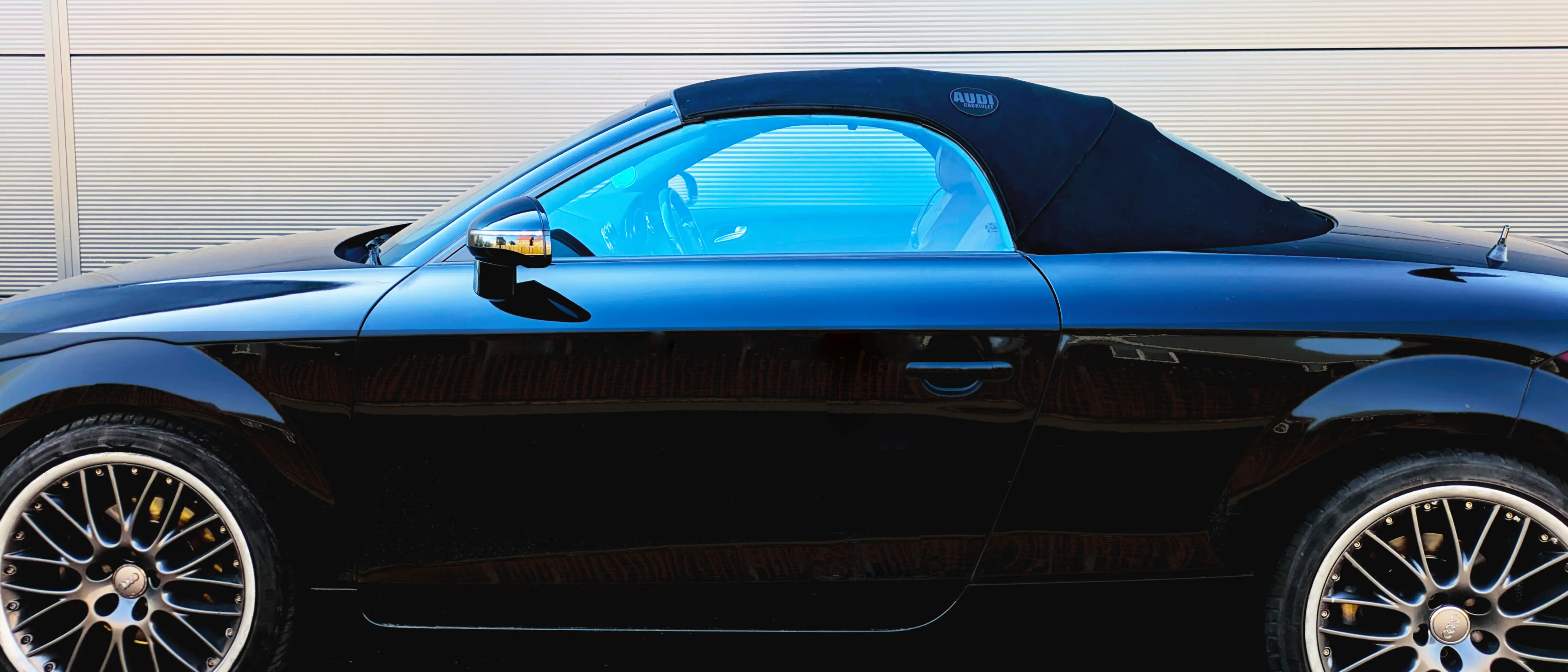 Convertible Roof Repair Guide: Common Pinch Points Official CabriTex™ 10cm precision repair patch applied to a black Audi TT convertible roof, sealing a common mechanical frame-rub hole.